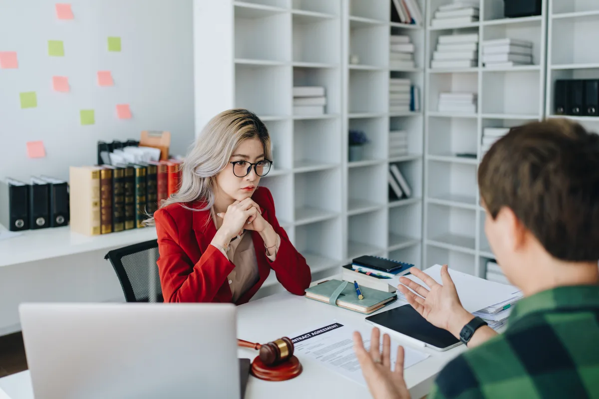 Family law attorney reviewing documents with a client during an initial consultation