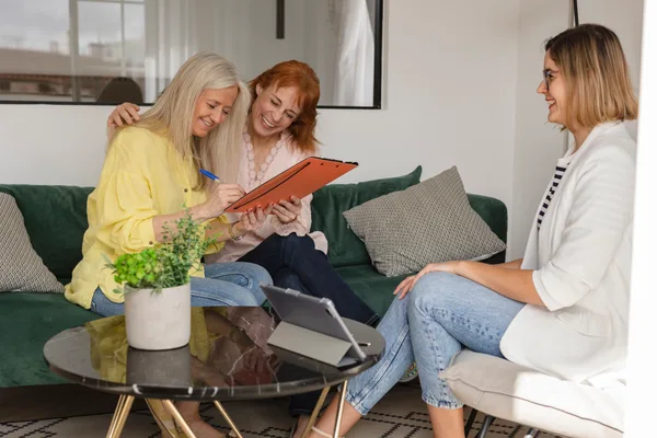 A property manager reviewing a management agreement with a rental property owner at a desk