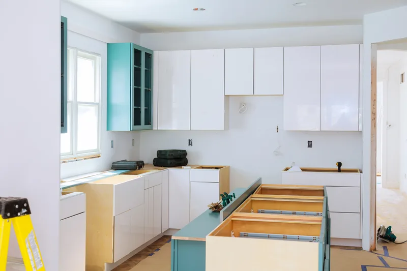 Kitchen mid-remodel: new base and wall cabinets installed, waiting for counters