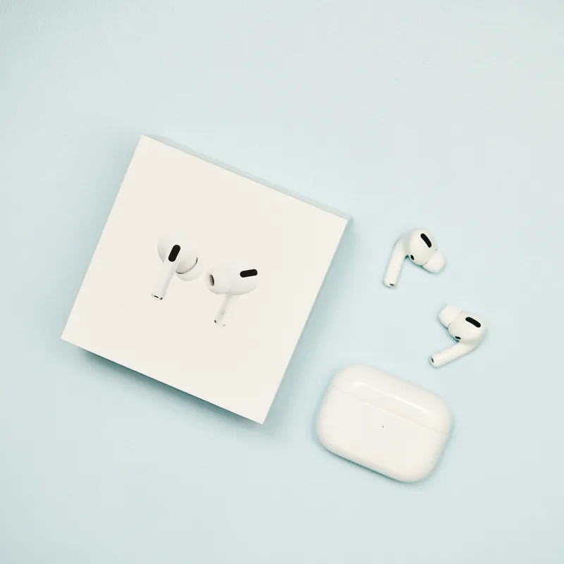 Wrenfield Aria true wireless earbuds resting beside their white charging case and retail box