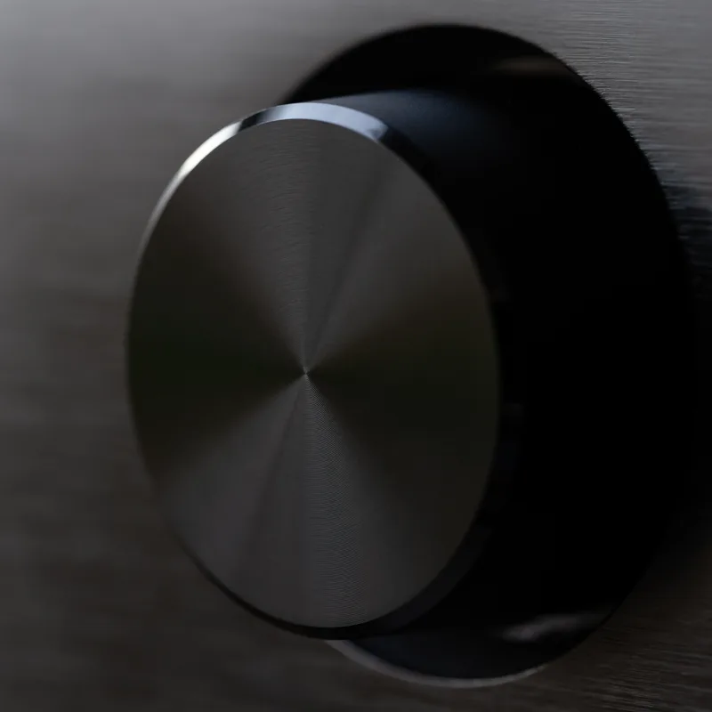 Close-up of the Voltbridge Solstice amplifier's machined aluminium volume knob on a brushed black faceplate