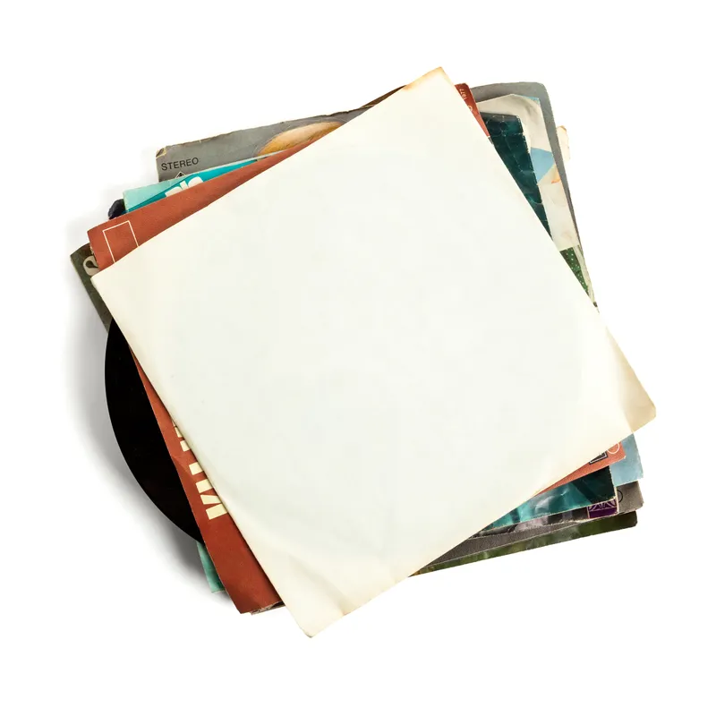 A well-loved stack of vinyl records in worn paper sleeves