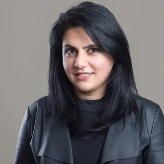 Portrait of Mara Sadeghi, a woman with long dark hair in a black jacket