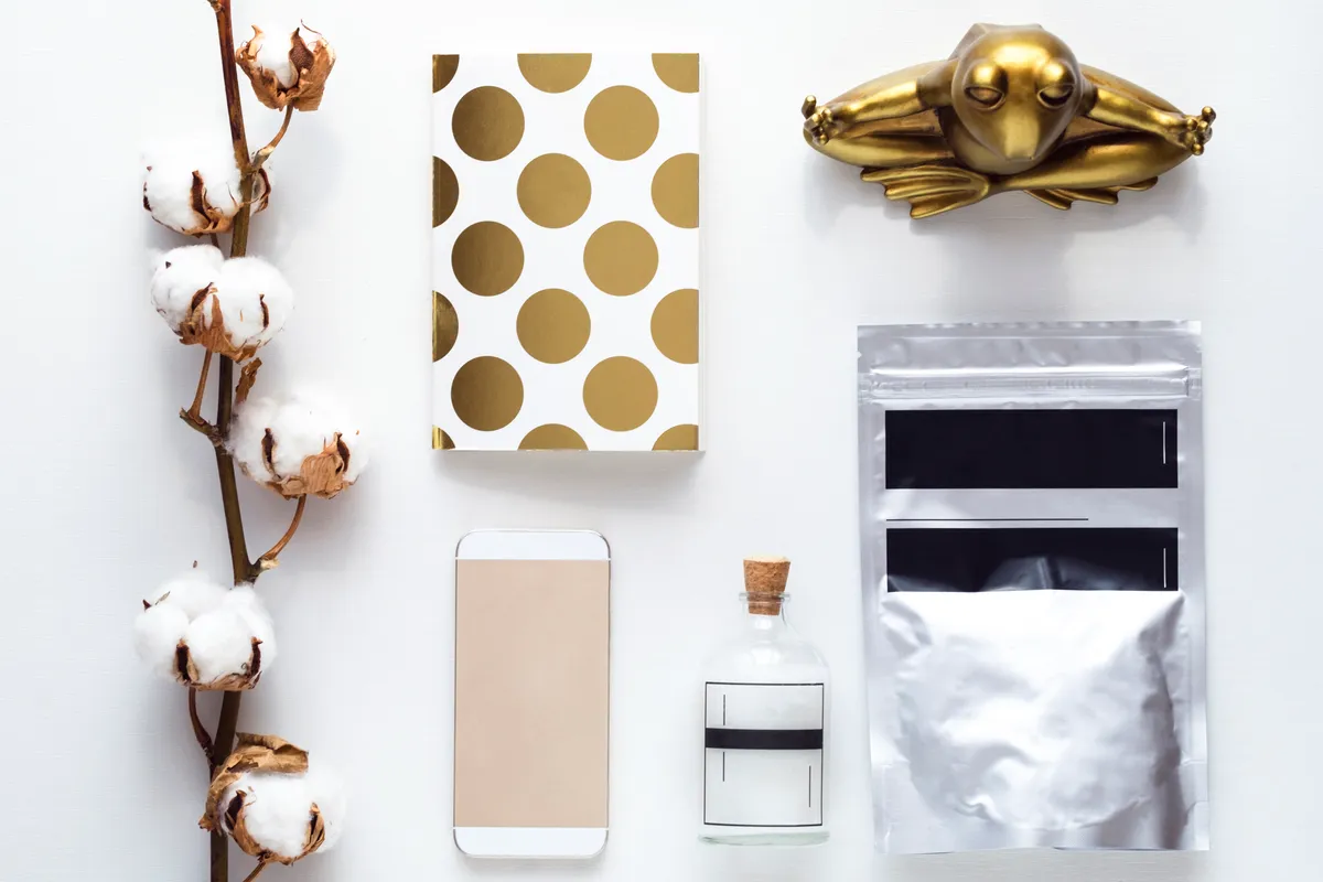Flat lay of sealed coffee pouches and packaging arranged on a white table