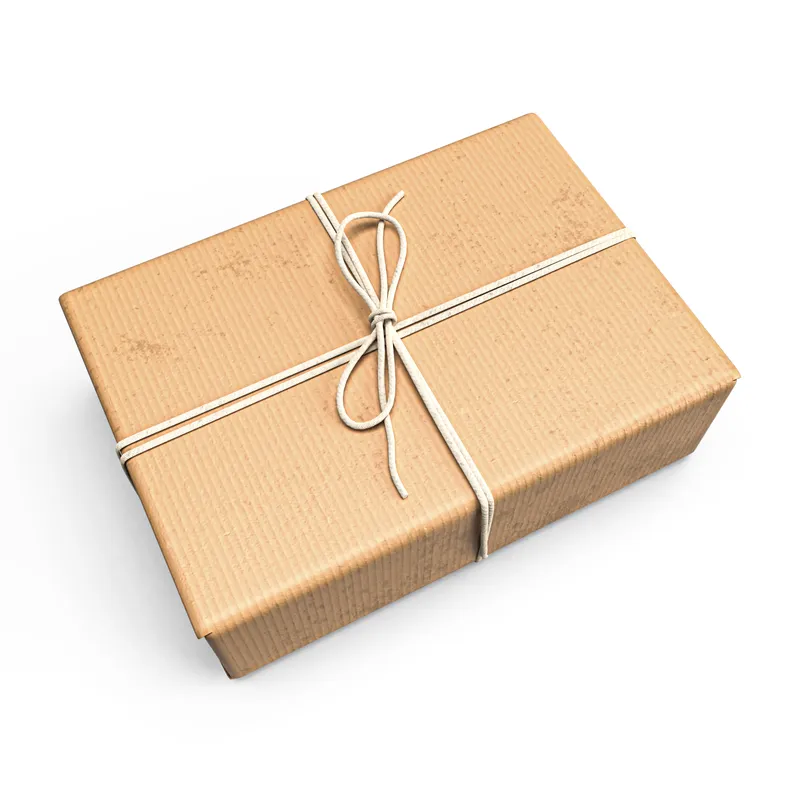 Kraft gift box tied with cotton twine containing the Ember & Oak three-roast coffee sampler