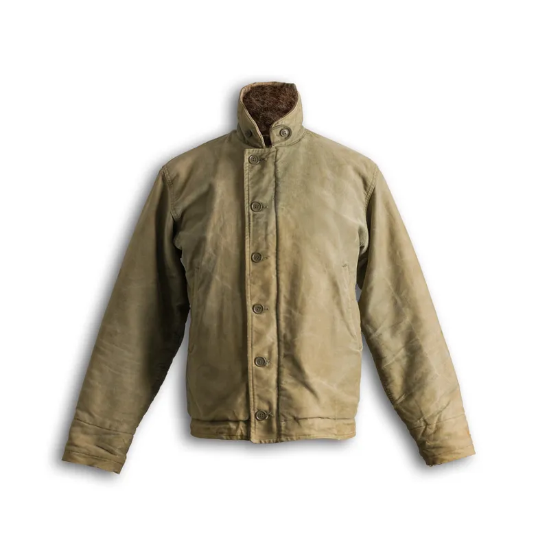 The moss-green deck jacket with shearling collar that survived the hundred-wear test, laid flat