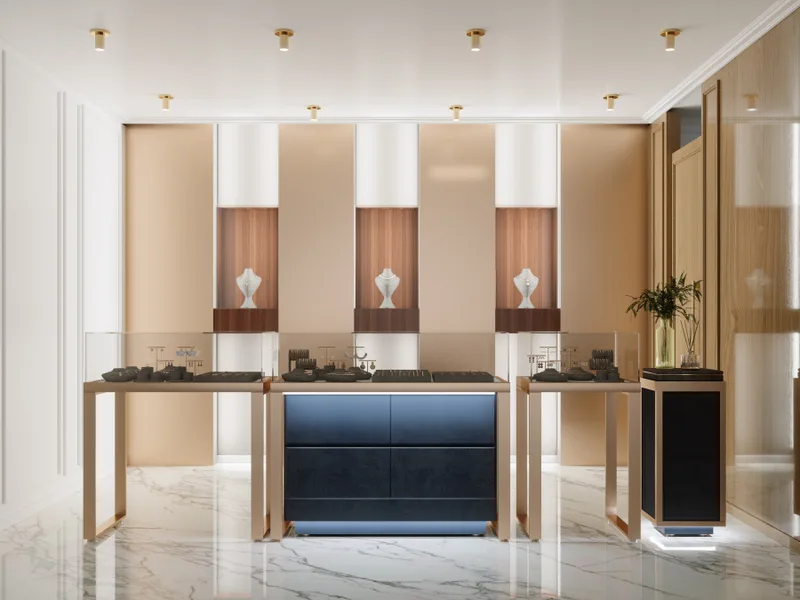 A quiet jewelry salon with marble floors, warm wood panels and glass cases lit from above