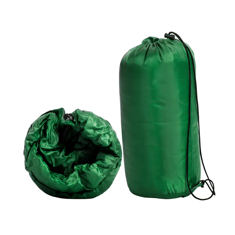 Forest-green Cirrus sleeping bag shown rolled beside its drawstring stuff sack