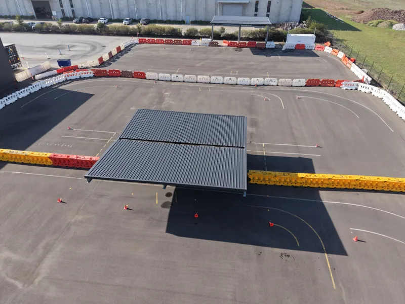 Closed practice lot marked with cones and barriers where first lessons and maneuverability drills happen