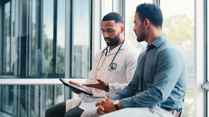 Riverbank physician reviewing results on a tablet with a patient beside a window wall
