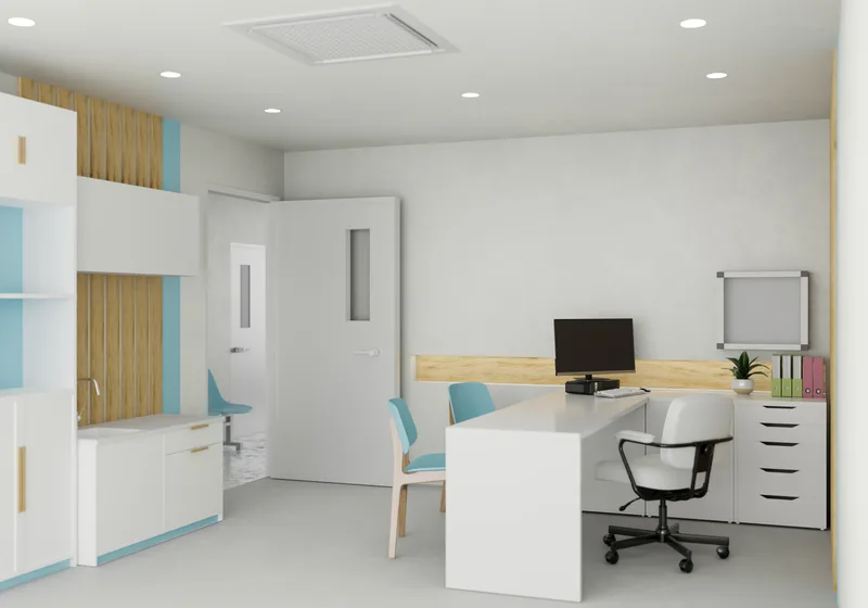 A bright, quiet consult office with a desk, a computer and a cabinet along the wall