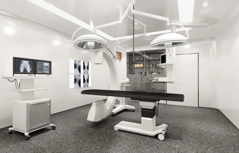 The Eastgate imaging suite — an X-ray table beneath twin exam lights with chest films displayed on wall monitors