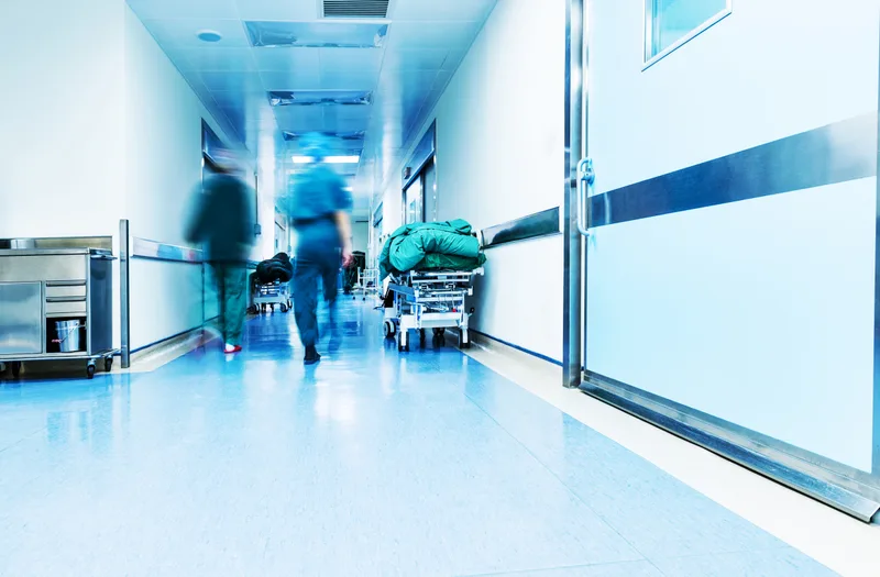 Clinicians moving through a bright blue-toned clinical corridor at the Downtown clinic