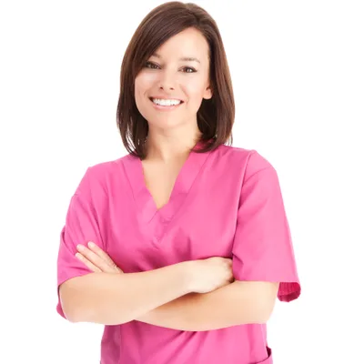 A smiling medical assistant in bright pink scrubs with arms crossed