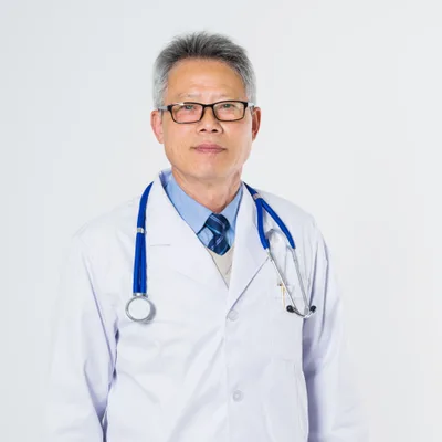 Dr. Kenneth Luong, a physician in a white coat with a blue stethoscope, smiling at the camera
