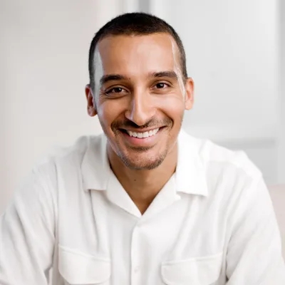 A smiling man in his thirties in a white shirt