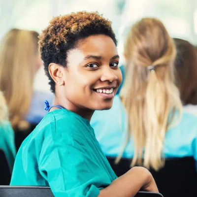 Nadia Brooks, cardiac sonographer, smiling in teal scrubs