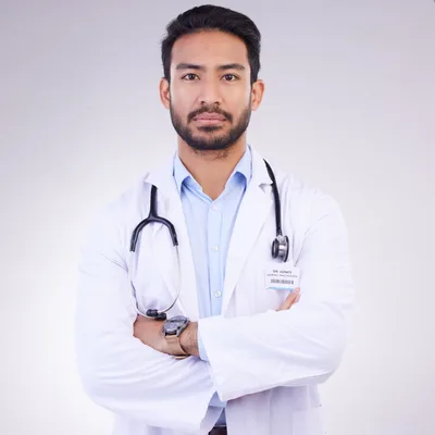 Dr. Marcus Villanueva in a white coat with a stethoscope, arms crossed