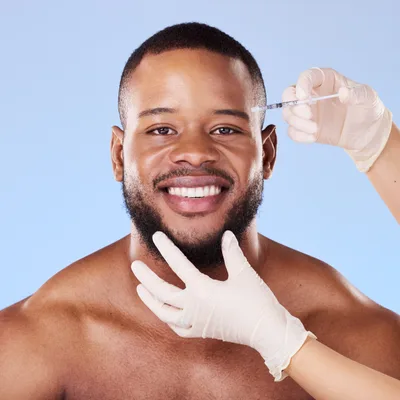 Daniel Osei, cardiology nurse, smiling with a stethoscope around his neck
