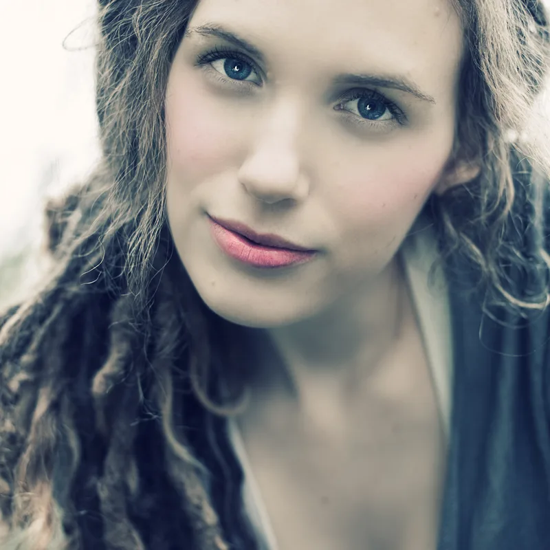 Close-up portrait of a young woman with a calm, steady expression