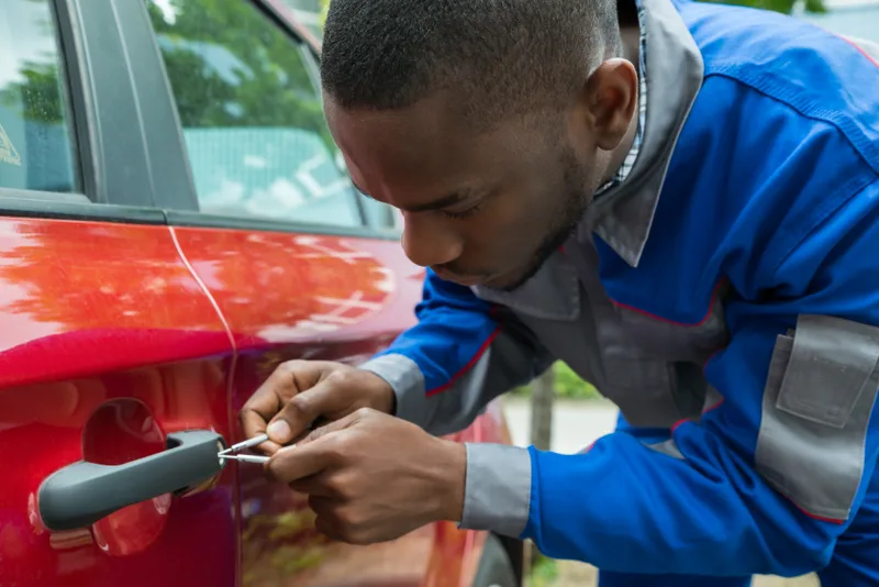 Pete, the automotive tech, opening a red car's door lock with picks