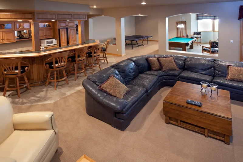 Finished basement family room with a sectional sofa, a bar and a pool table