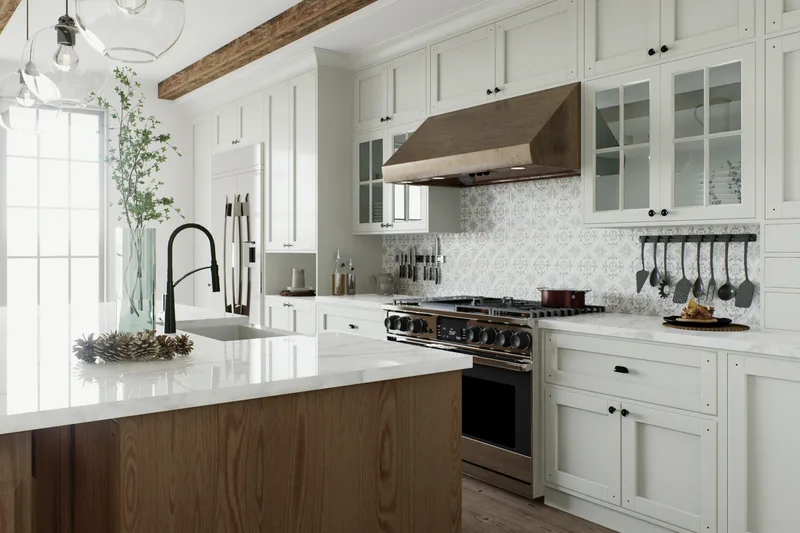 Bright kitchen with a stainless steel gas range under a range hood, white cabinets and an island