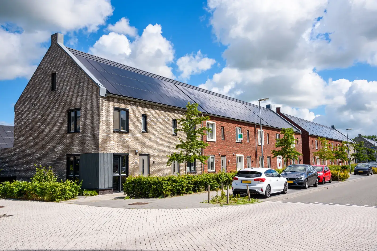 Row of townhomes with rooftops fully covered by solar panels