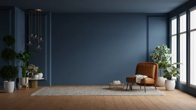 Calm living room with a deep blue wall, a leather armchair and a warm oak floor