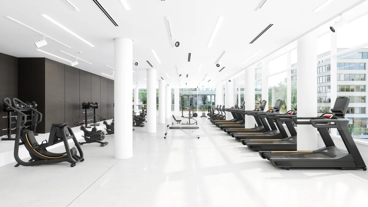 Member training under a coach in a modern gym