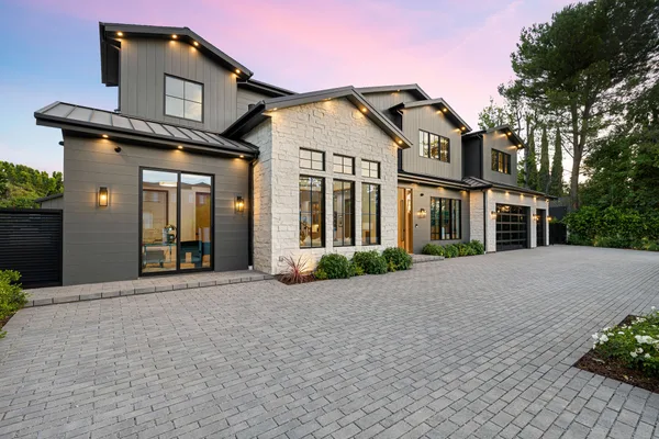 Modern home exterior listed for sale by a real estate team