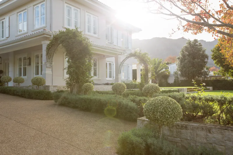 Morning sun over a family home and its green front garden