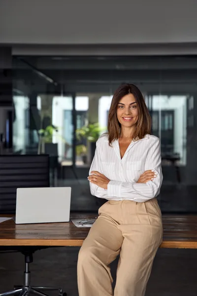 Portrait of Teresa Soto, arms folded, in an office