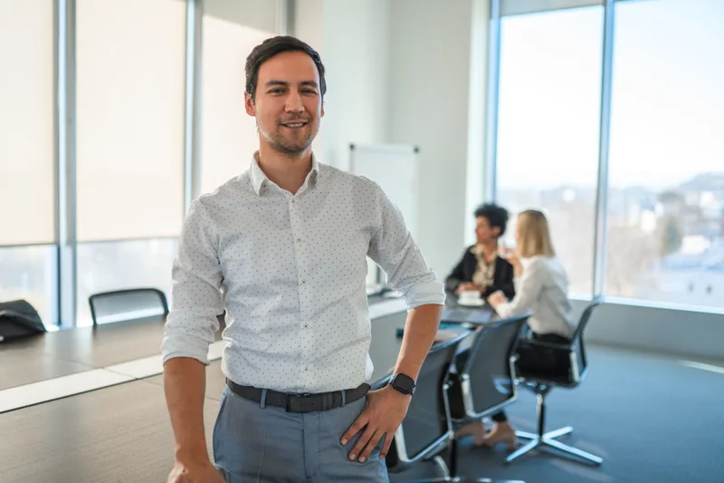 Portrait of attorney Ken Moriyama standing in a bright office