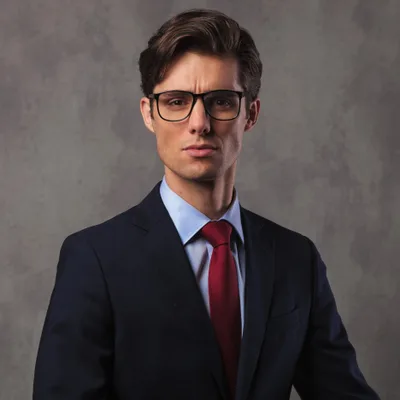 Jonah Brandt, a young associate attorney in glasses and a navy suit with a red tie