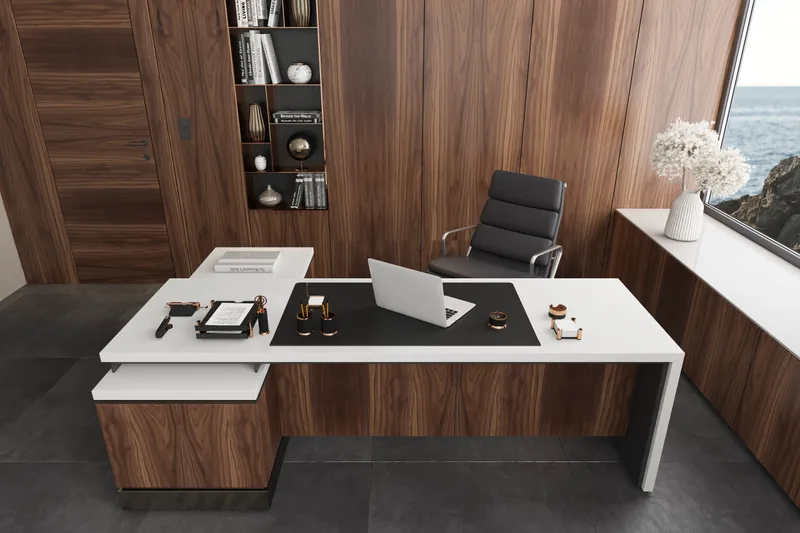 A white and walnut desk with a laptop and a leather chair in a quiet office with a water view