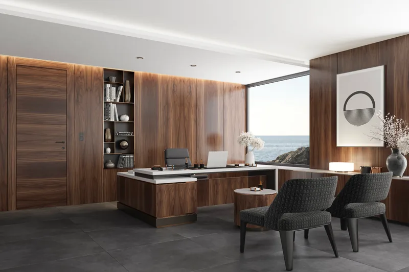 A wood-panelled office with a desk, two armchairs and a wide window looking out over the water