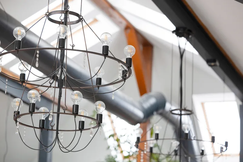Iron ring chandeliers hanging beneath the white-limed timber ceiling of the great hall