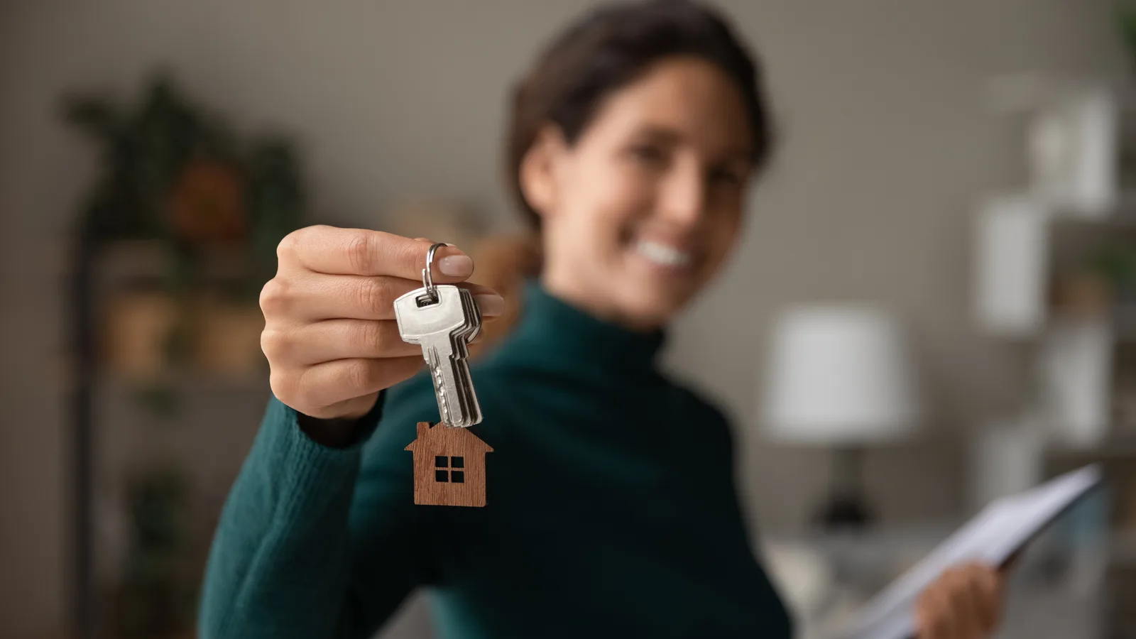 A leasing agent showing a prospective resident a bright, furnished apartment unit during a tour