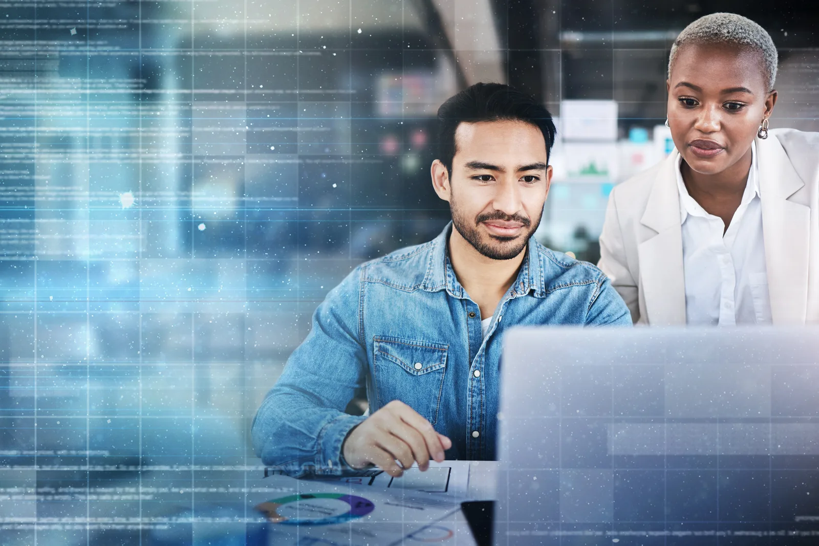 Application security engineers reviewing scan findings on a code review dashboard together at a laptop in their office