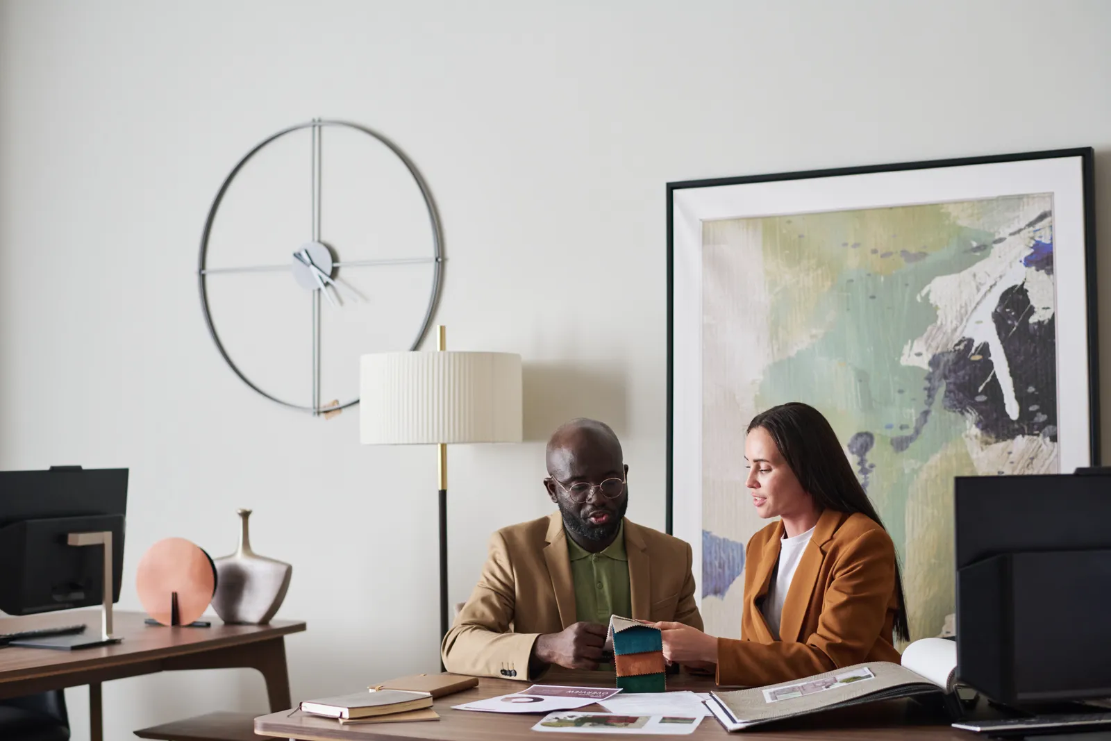 Art law attorney reviewing a painting's provenance documents with a collector at a conference table