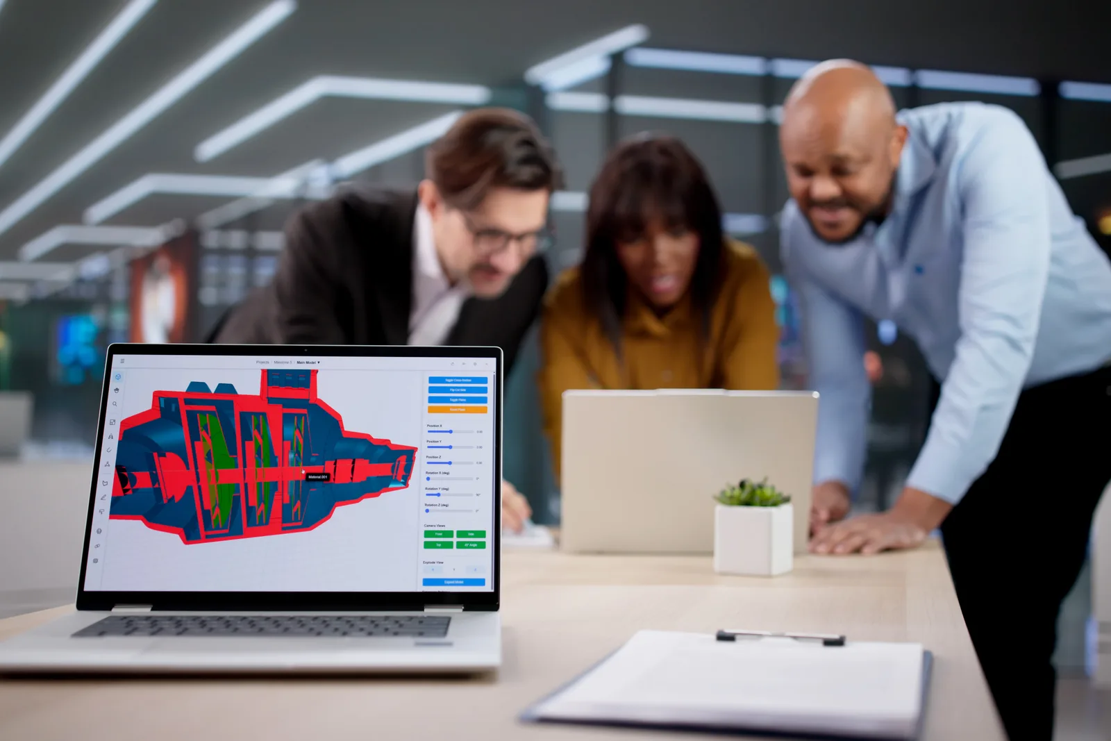 Auto repair shop software team reviewing a digital vehicle inspection dashboard together at a laptop in their office
