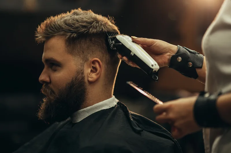 Barber giving a client a haircut in a barbershop