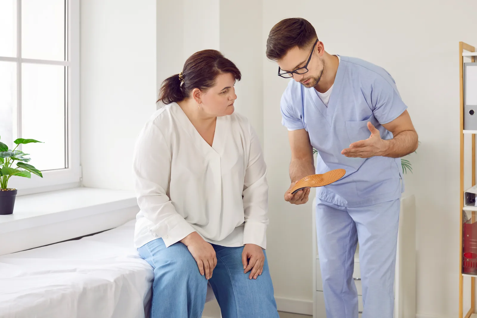 Bariatric surgeon discussing gastric sleeve and gastric bypass options with a patient during a consultation