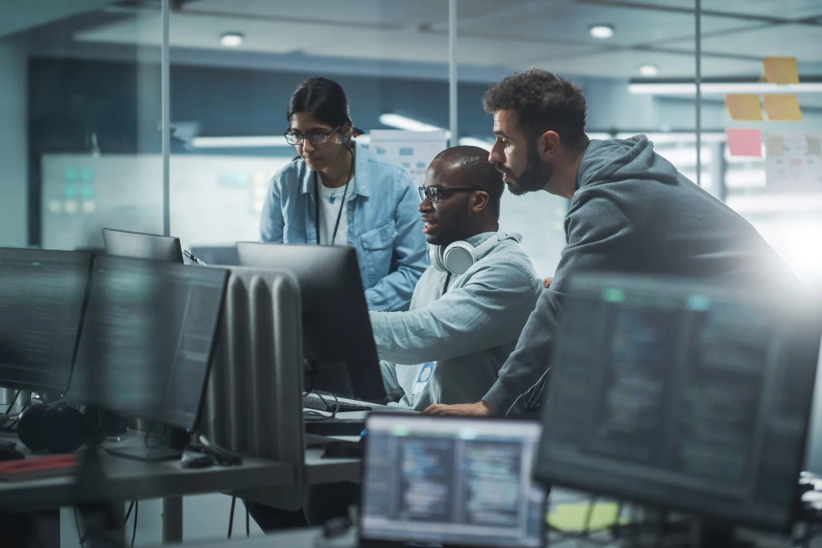 Billing software team reviewing a recurring-revenue and failed-payment dashboard together at a laptop in their office
