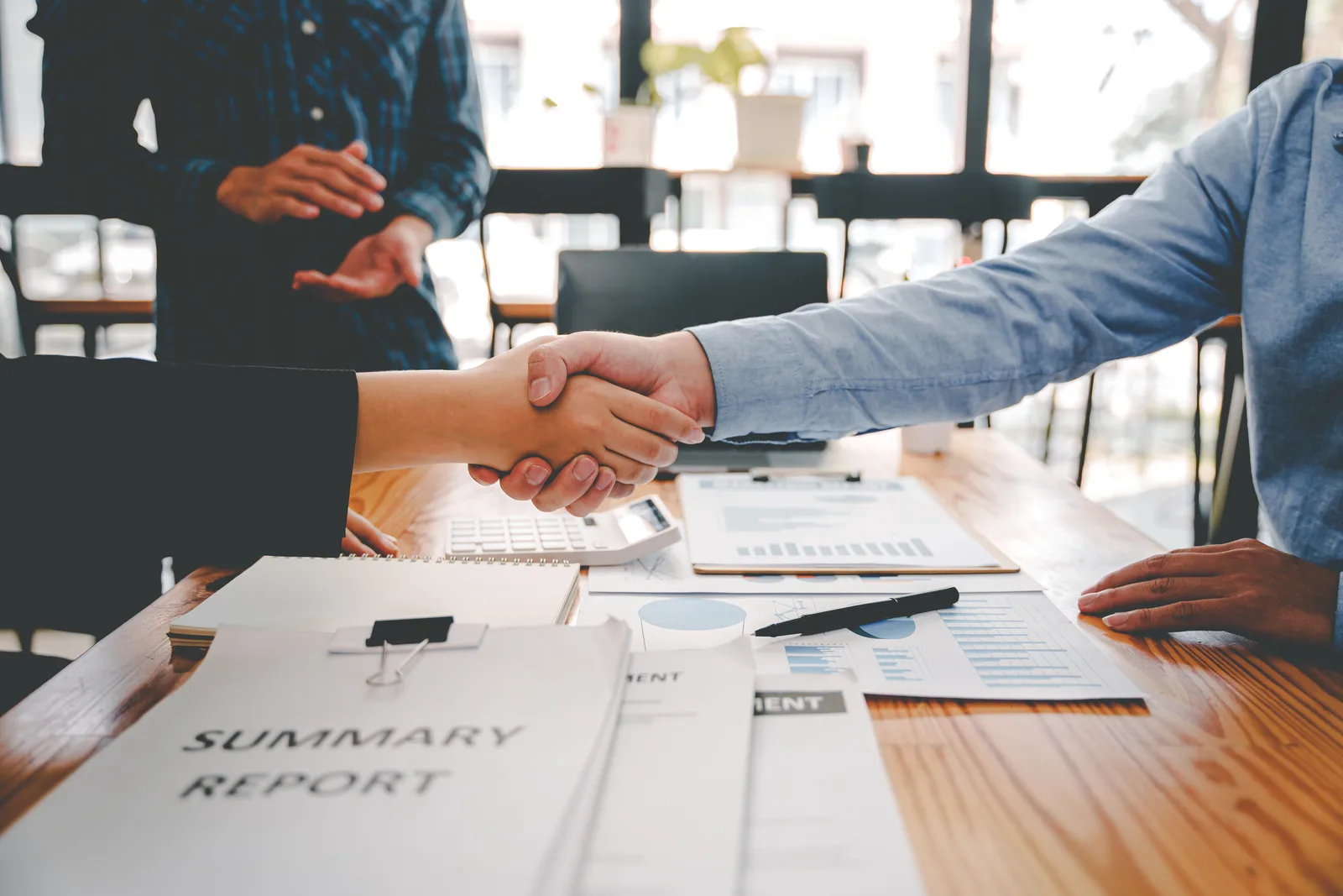 Business broker reviewing a valuation and deal summary with a business owner across a conference table