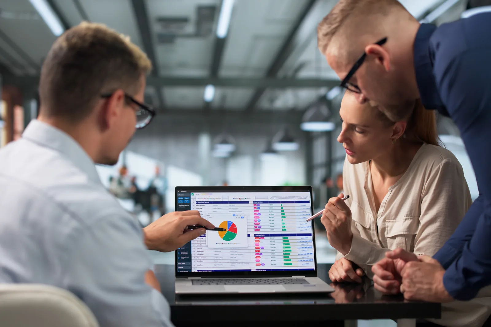 Software team reviewing seed-to-sale compliance and POS dashboard metrics together on a laptop