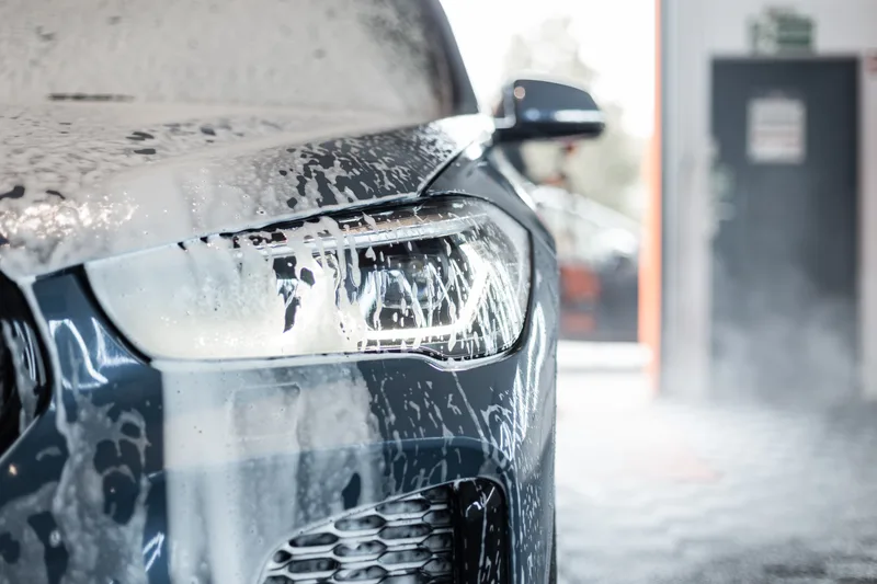 Car going through an automatic car wash with foam