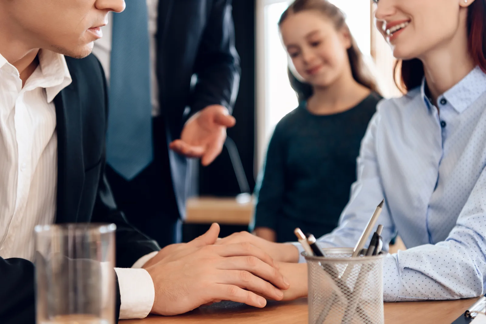 Child support attorney reviewing a support payment worksheet with a client at his office desk