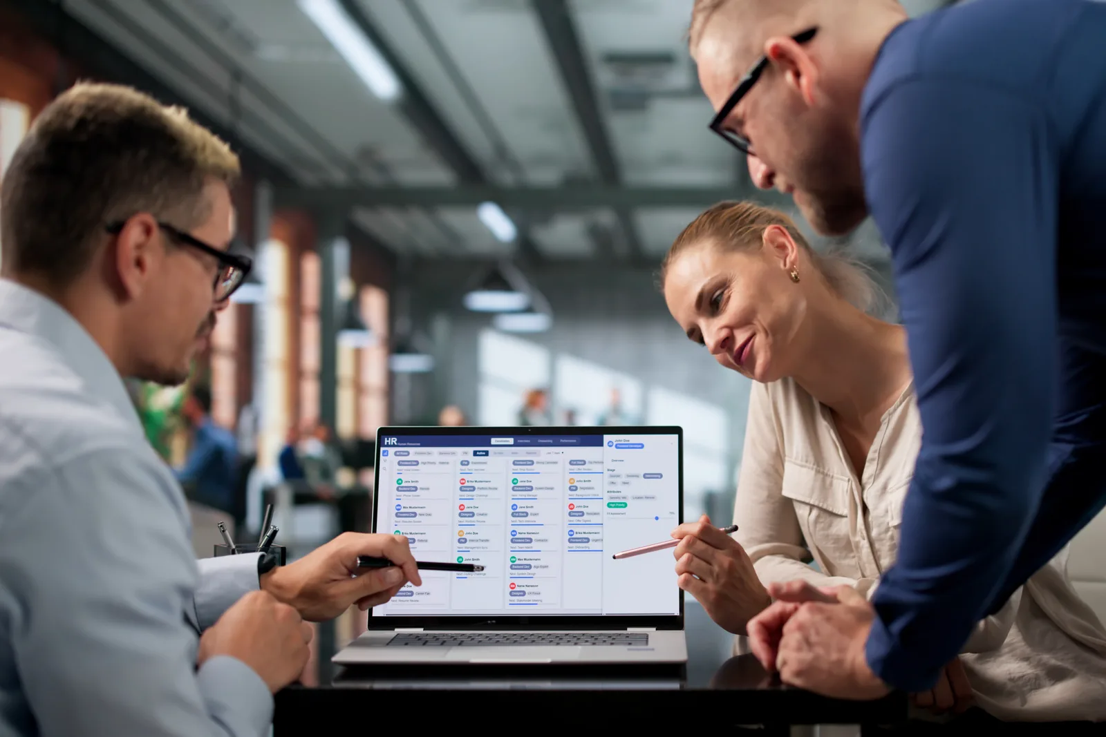 Software team reviewing a chiropractic scheduling and SOAP-note documentation dashboard together at a laptop in their office